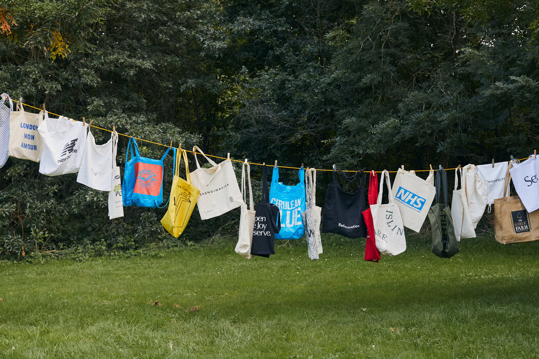 人们争先用环保袋取代塑料袋以后，一个消费者积累的棉质环保袋挂在一条晾衣线上。